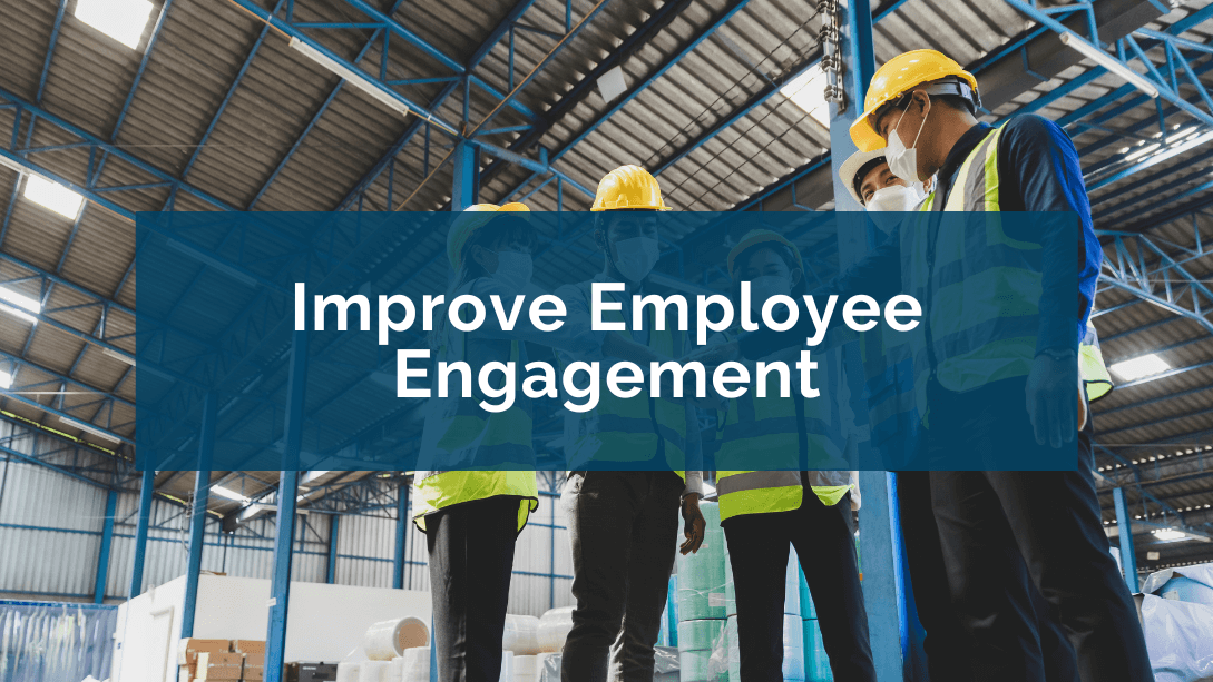 Group of employees wearing safety vests and helmets, joining hands as a sign of team engagement